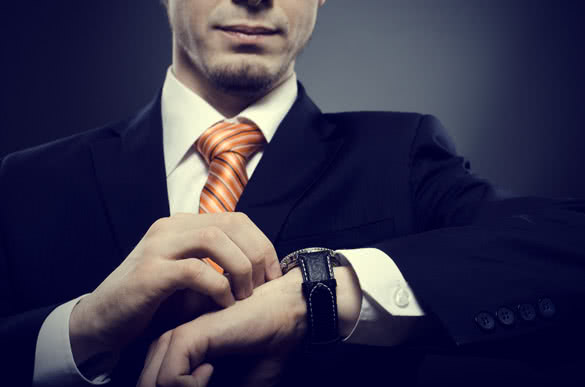 man-in-suit-looking-at-his-watch.jpg