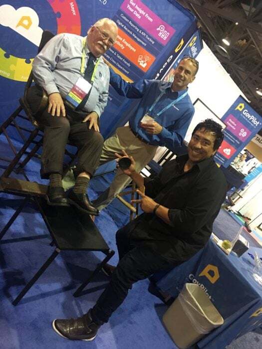 Clockwise: a conference attendee, GovPilot Senior Account Executive, Dan Iannascolio and shoe shine professional, June De La Paz.